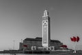Hassan II Mosque of Casablanca black and white landscape with red Moroccan flags