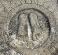 Hassan, Karnataka, India - September 12, 2009 Ancient stone bas relief of feet of Chandragupta Maurya