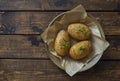 Hasselblad potatoes oven  baked with spices and olive oil on dark wooden table Royalty Free Stock Photo