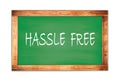 HASSLE FREE text written on green school board