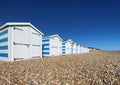 Hastings, East Sussex, UK -03.15.2022: Hastings seafront beach huts on summer day beautiful blue white striped huts on pebble beac Royalty Free Stock Photo