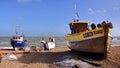 HASTINGS, UK - JUNE 15, 2013: A beach launched fishing boat with strong waves in the background