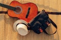 Hat, Bag and Guitar on reed mat near the sea at sunset. Travel, vocation, holiday, summer concept Royalty Free Stock Photo