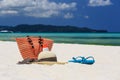 Hat, bag, sun glasses and flip flops on tropical beach Royalty Free Stock Photo