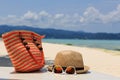 Hat, Bag, Sun Glasses And Flip Flops On Tropical Beach