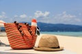 Hat, bag, sun glasses and flip flops on tropical beach Royalty Free Stock Photo