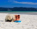 Hat, bag, sun glasses and flip flops on tropical beach Royalty Free Stock Photo