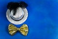 Hat and bow tie, blue background, party, carnival, New Year`s Royalty Free Stock Photo
