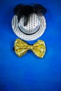 Hat and bow tie, blue background, party, carnival, New Year`s Royalty Free Stock Photo