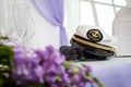 The hat of the captain on the table with binoculars and flowers Royalty Free Stock Photo