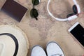 hat, eyeglasses, passport, headphone, white sneakers and mobile