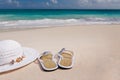 Hat and flip-flops on the beach Royalty Free Stock Photo