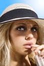 Hat girl with drink Royalty Free Stock Photo