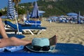 Hat and glasses on the beach background. A man is lying on a sun lounger. Royalty Free Stock Photo