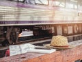 Hat and notebook on bench at train station Royalty Free Stock Photo