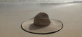 Hat on the sand. Cool fashionable photo. Romantic nice composition. Concept photo in the tropical beach near ocean.