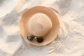 hat summer - straw hat fasion and sunglasses accessories on sandy beach sea background top view Royalty Free Stock Photo