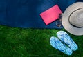 Hat, sunglasses, flip flops on the green grass. Summer vacation concept. Copy space. Royalty Free Stock Photo