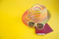 hat , sunglasses , passport on a yellow background Top view essential travel items. Summer holiday background. Travel planning. A