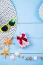 Hat and sunglasses with shells, starfishes, gift box and rope on Royalty Free Stock Photo