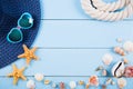 Hat and sunglasses with shells, starfishes and rope on blue wood Royalty Free Stock Photo