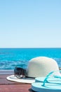 Hat Sunglasses Slippers on Blue Sky and Turquoise Sea Background. Summer Vacation Travel Relaxation. Idyllic Seascape View