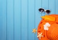 Hat, sunglasses and suntan lotion on wood background colored. Royalty Free Stock Photo