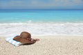 Hat and towel on a beach Royalty Free Stock Photo