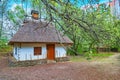 The hata house behind the branches, Mamajeva Sloboda Cossack Village, Kyiv, Ukraine