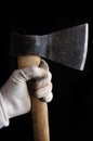Hatchet ax in hand isolated on black background Royalty Free Stock Photo