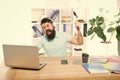 Hate office routine. Man bearded guy headphones office swing hammer on computer. Slow internet connection. Outdated Royalty Free Stock Photo