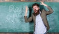 Hate school. Teacher goes mad about schooling. Teacher or educator stands near chalkboard with inscription back to Royalty Free Stock Photo