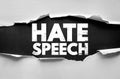 HATE SPEECH message on torn paper background. Concept of discrimination, harmful communication, online abuse prevention, equality Royalty Free Stock Photo
