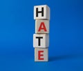 Hate symbol. Concept word Hate on wooden cubes. Beautiful blue background. Business and Hate concept. Copy space Royalty Free Stock Photo