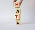 Hate symbol. Concept word Hate on wooden cubes. Businessman hand. Beautiful white background. Business and Hate concept. Copy Royalty Free Stock Photo