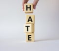 Hate symbol. Concept word Hate on wooden cubes. Businessman hand. Beautiful white background. Business and Hate concept. Copy Royalty Free Stock Photo