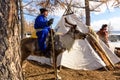 Hatgal, Mongolia, Febrary 25, 2018: Little tsaatan boys in traditional Mongolian riding on reindeers.