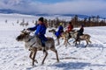 Hatgal, Mongolia, Febrary 25, 2018: Little tsaatan boys in traditional Mongolian riding on reindeers.