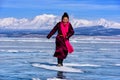 Hatgal, Mongolia, Febrary 23, 2018: mongolian girl wears in traditional clothes has fun on a frozen lake Khuvsgul