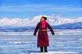 Hatgal, Mongolia, Febrary 23, 2018: mongolian girl wears in traditional clothes has fun on a frozen lake Khuvsgul