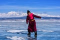 Hatgal, Mongolia, Febrary 23, 2018: mongolian girl wears in traditional clothes has fun on a frozen lake Khuvsgul