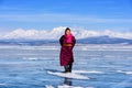 Hatgal, Mongolia, Febrary 23, 2018: mongolian girl wears in traditional clothes has fun on a frozen lake Khuvsgul