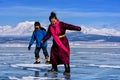 Hatgal, Mongolia, Febrary 23, 2018: mongolian girl and boy wears in traditional clothes has fun on a frozen lake