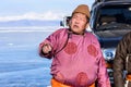 Hatgal, Mongolia, Febrary 23, 2018: mongolian man dressed in traditional clothing on a frozen lake Khuvsgul