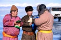 Hatgal, Mongolia, Febrary 23, 2018: mongolian people dressed in traditional clothing on a frozen lake Khuvsgul and