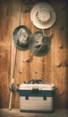 Hats hanging on wall with fishing equipment