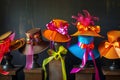 hats with vibrant ribbons and bows showcased on pedestals