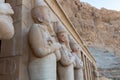 The Hatshepsut statues by the columns on the highest terrace of the Mortuary Temple of Hatshepsut, Luxor, Egypt