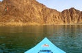 Hatta UAE - July 18, 2020: United Arab Emirates flag waving on top of a hill in the Middle of Hatta lake with blue