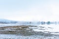 Tourists stand around Strokkur and wait the eruption. Valley of Geysers Haukadalur in the Royalty Free Stock Photo